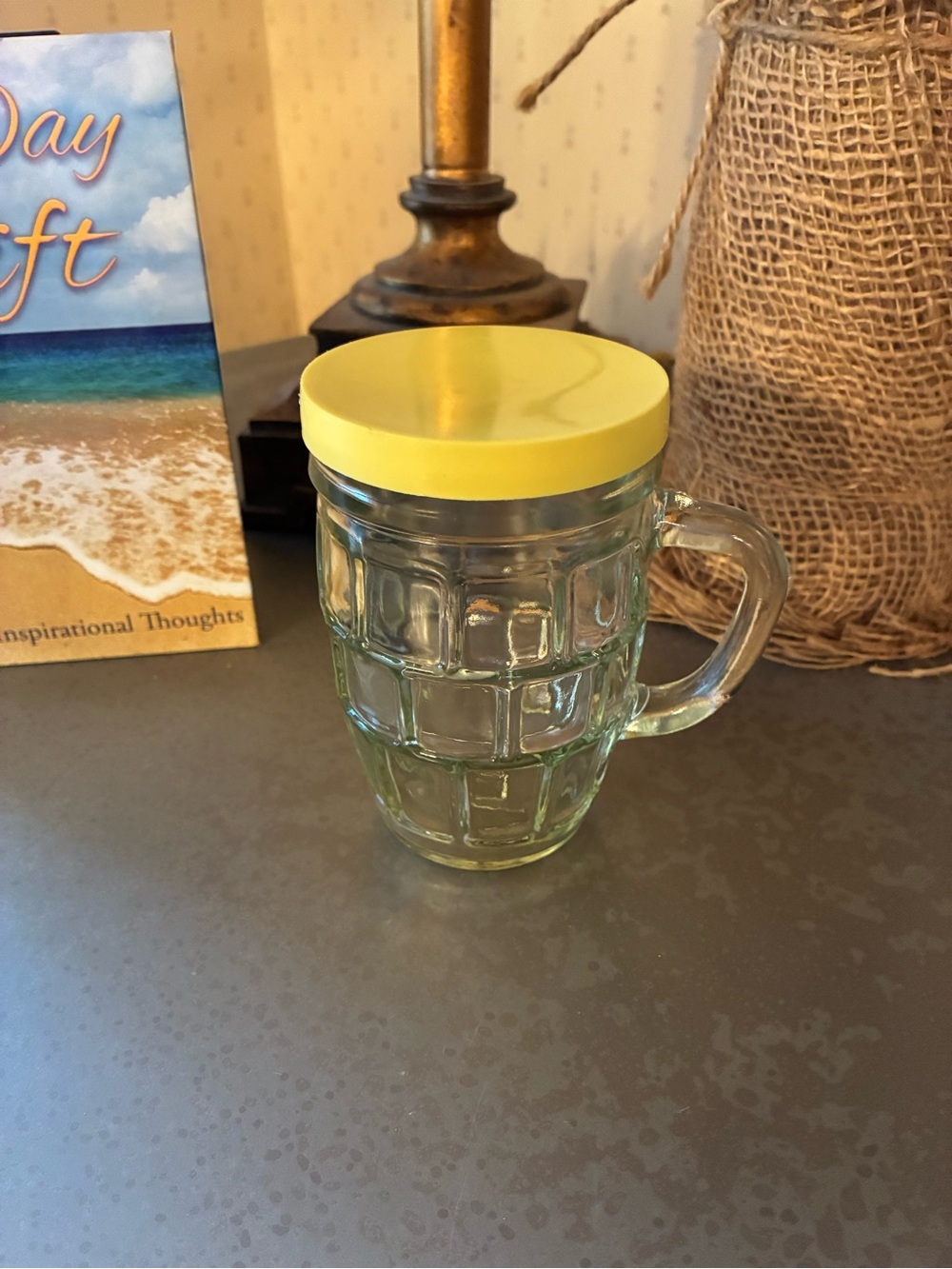 Vintage. CLEAR embossed glass mustard jar with a handle, YELLOW cover. 4.25 tall